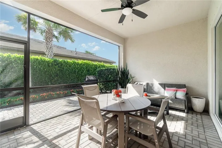 Sunroom featuring a ceiling fan and outdoor dining space