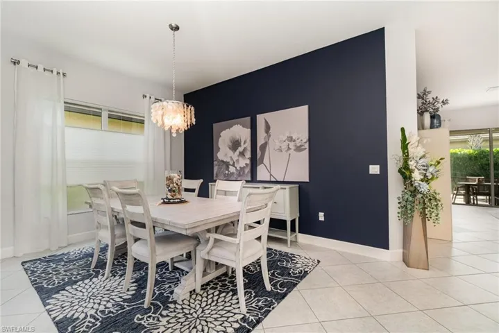 Dining area featuring an accent wall and top down bottom up blinds.