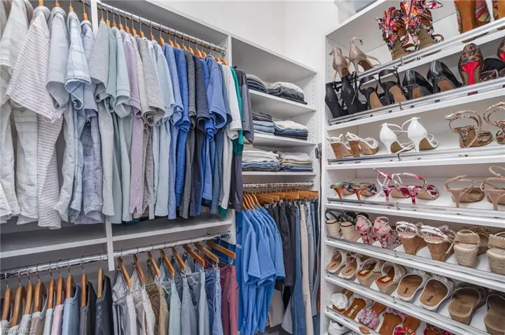 Primary designer closet number 2 with built-in shelving and two shoe organizers.