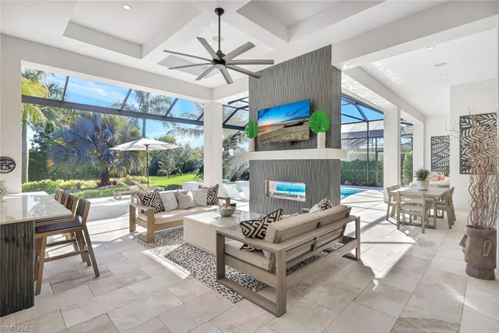 View of patio / terrace with outdoor dining area, a lanai, a sunroom, and a ceiling fan