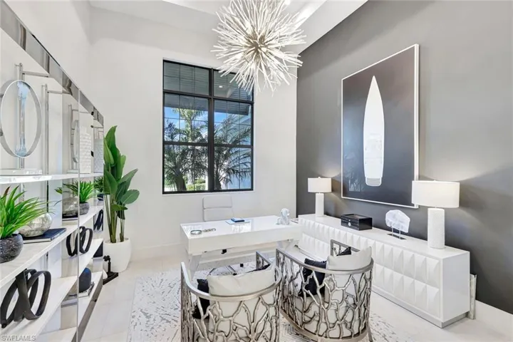 Tiled home office with a chandelier and baseboards