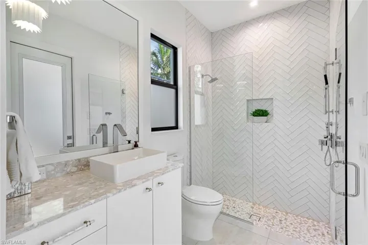 Bathroom featuring vanity, a stall shower, and light tile patterned floors