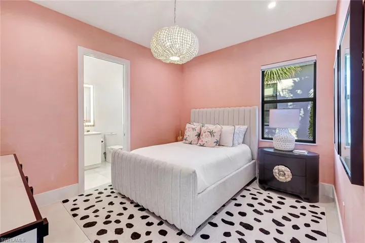 Bedroom featuring connected bathroom, light tile patterned flooring, a chandelier, and recessed lighting