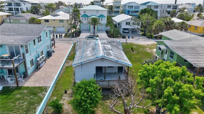 The shite house is on 191 Primo Dr this listing. NOTE: the green home is 171 Primo Dr and also for sale by the same owner.