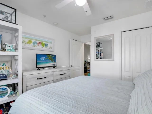 Bedroom with ceiling fan and a closet