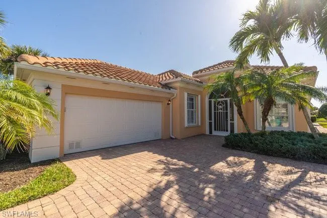 Mediterranean / spanish home with a garage