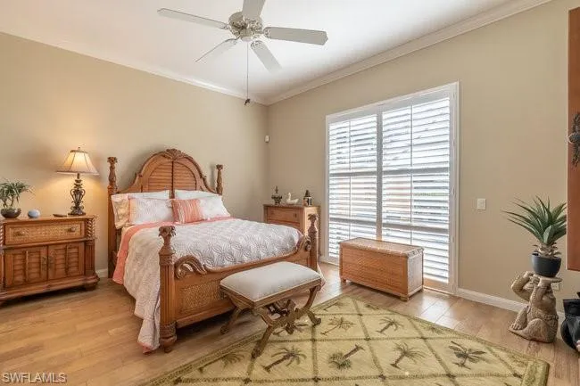 Bedroom featuring ceiling fan, light hardwood / wood-style floors, and ornamental molding