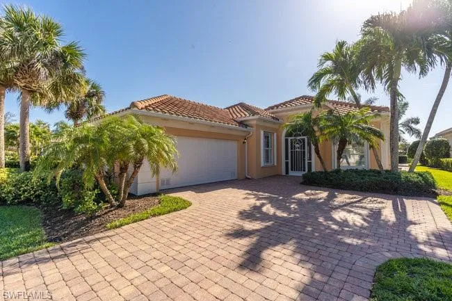 Mediterranean / spanish home with a garage