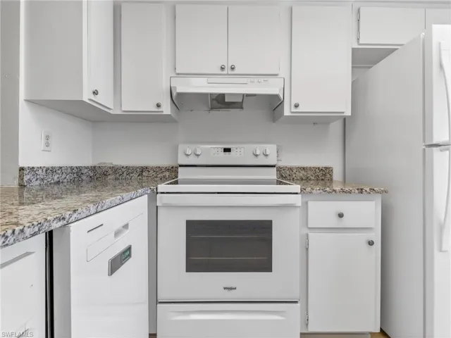 Kitchen featuring white cabinetry, granite-look countertops, a built-in dishwasher, and a white electric range