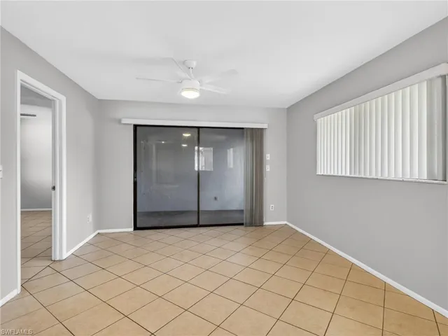 Spacious room featuring neutral wall tones and diagonal tile flooring