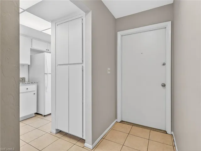 Tiled flooring extending from the entry into the kitchen