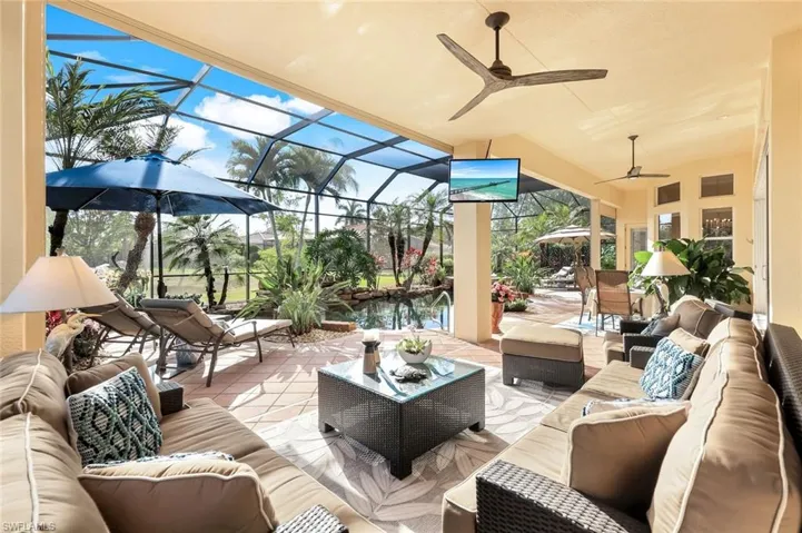 View of patio / terrace with an outdoor living space, a ceiling fan, a sunroom, and glass enclosure