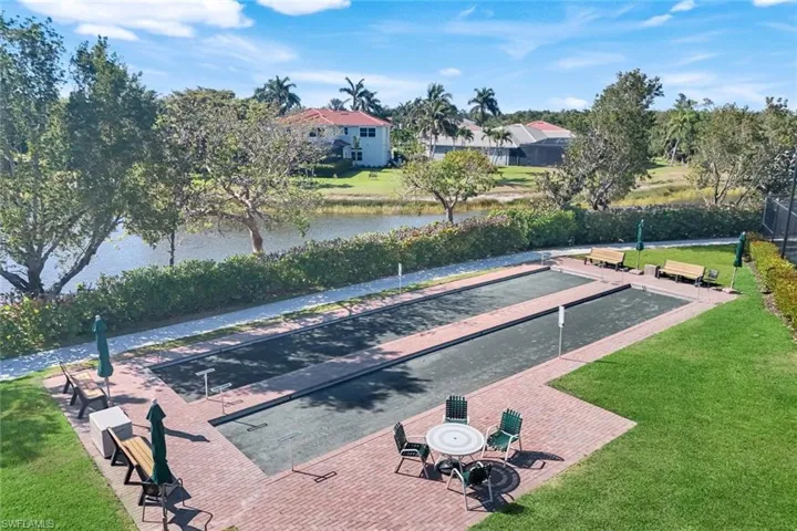 Surrounding community with a bocce ball area, a water view, and a patio