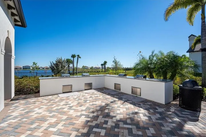 View of patio featuring an outdoor kitchen and fence