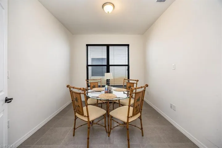 Tiled dining room with baseboards