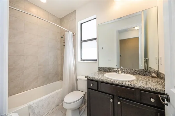 Full bath featuring vanity, toilet, and shower / tub combo