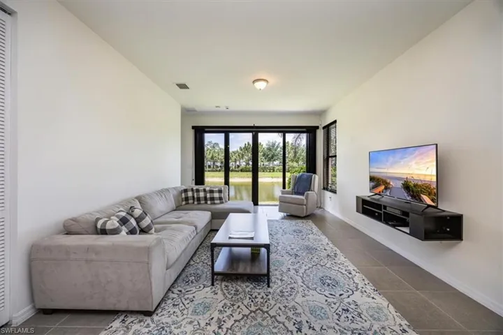 Tiled living area with baseboards and visible vents