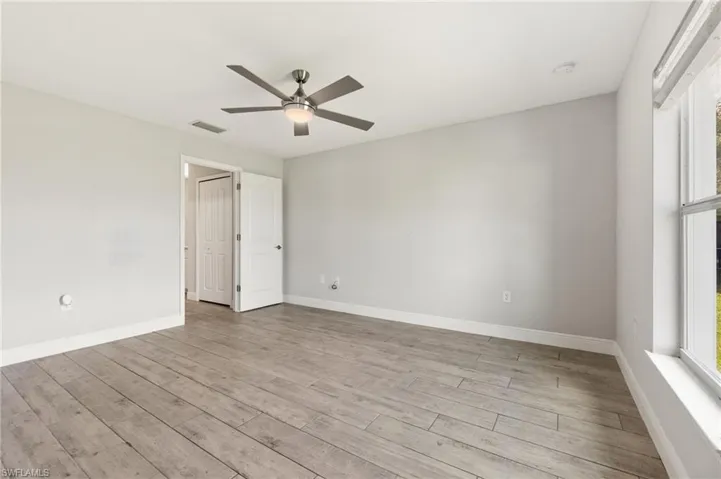 Spare room with light wood-style floors and ceiling fan