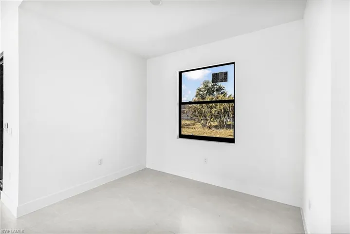 Empty room featuring baseboards