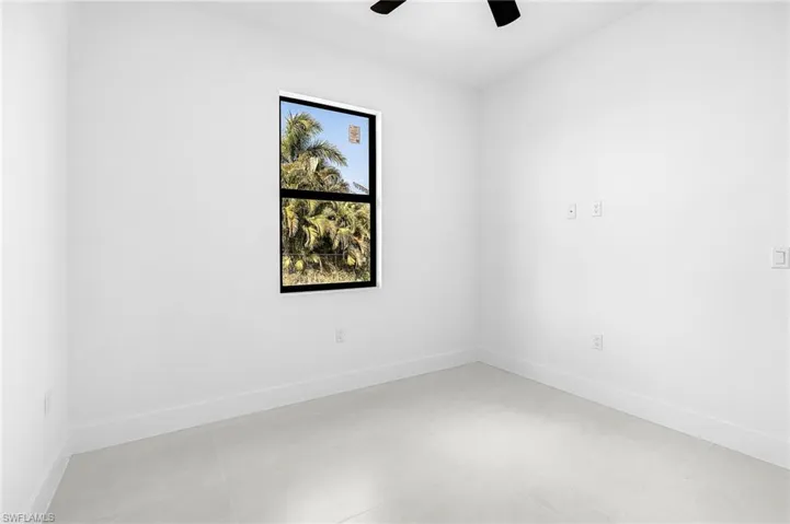 Spare room with baseboards and ceiling fan
