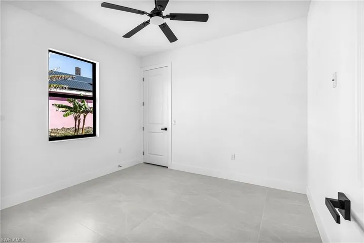 Spare room featuring baseboards and a ceiling fan