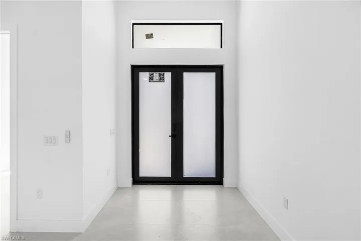Foyer entrance with baseboards and french doors