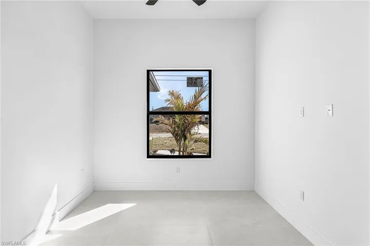 Spare room featuring baseboards and a ceiling fan