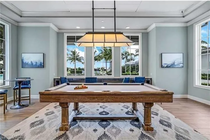 Playroom with light hardwood / wood-style floors, ornamental molding, and billiards