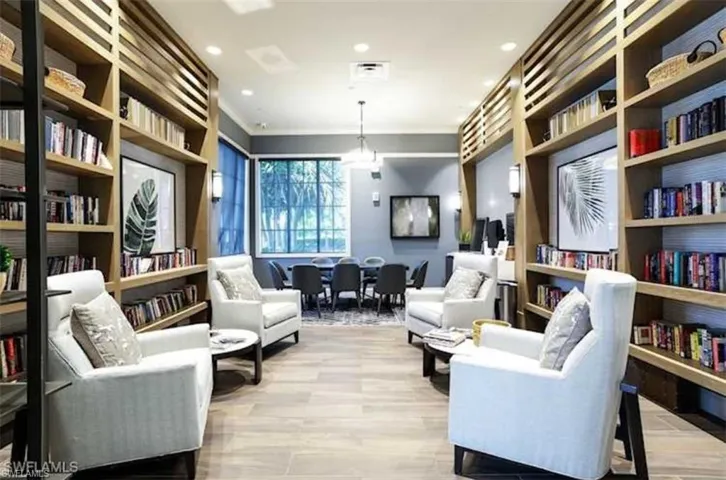Sitting room with light hardwood / wood-style floors and ornamental molding