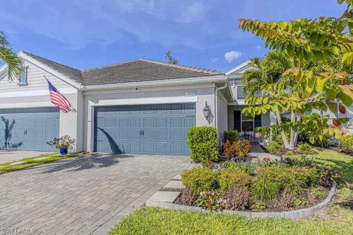 Ranch-style home with decorative driveway, stucco siding, a garage, and a tile roof