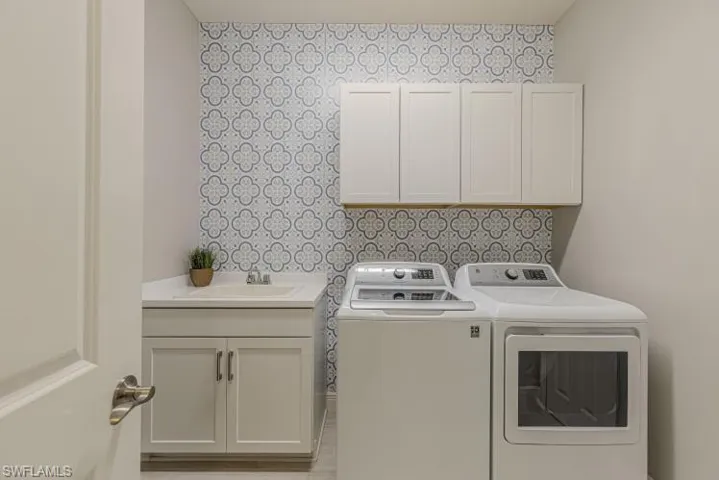 Laundry room with washer and dryer and cabinet space