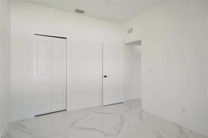 Tiled bedroom with a closet