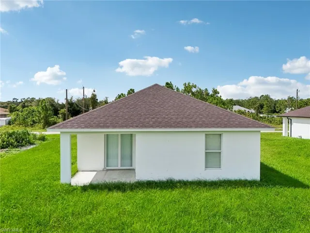 View of side of property featuring a lawn