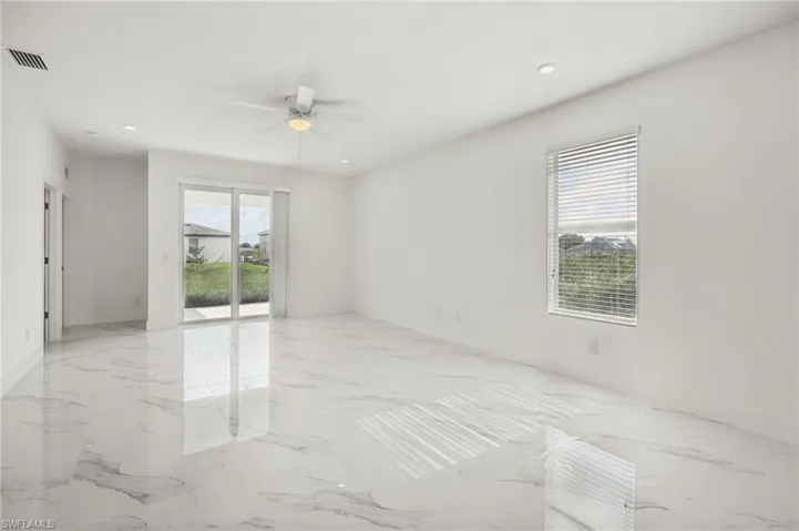 Tiled spare room with ceiling fan