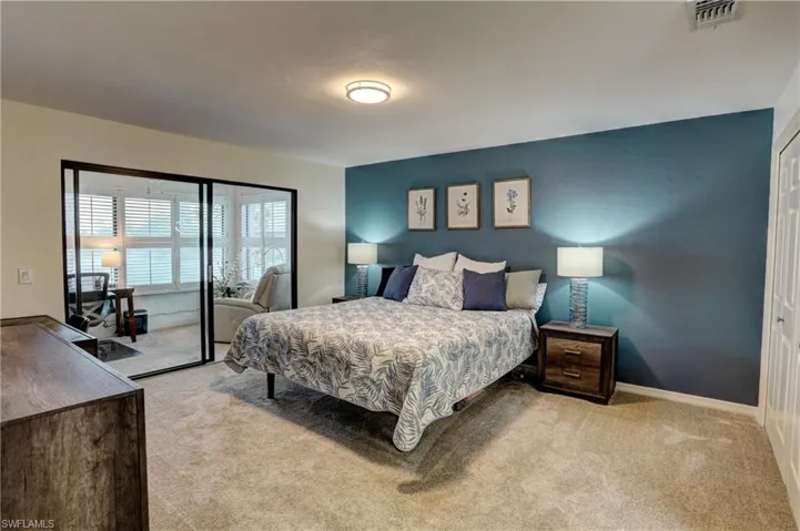 Bedroom with a closet and light colored carpet