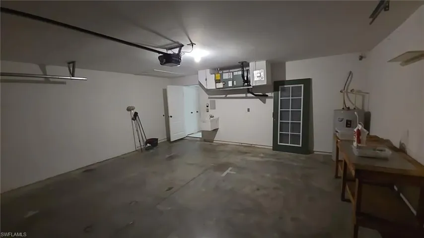Garage featuring a sink and a garage door opener
