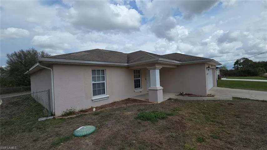 View of property exterior with an attached garage, stucco siding, and a shingled roof