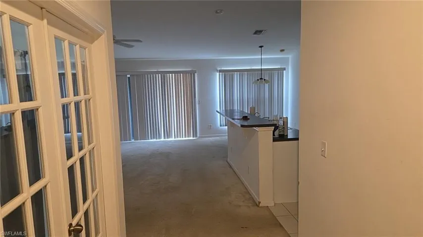 Hall featuring light colored carpet