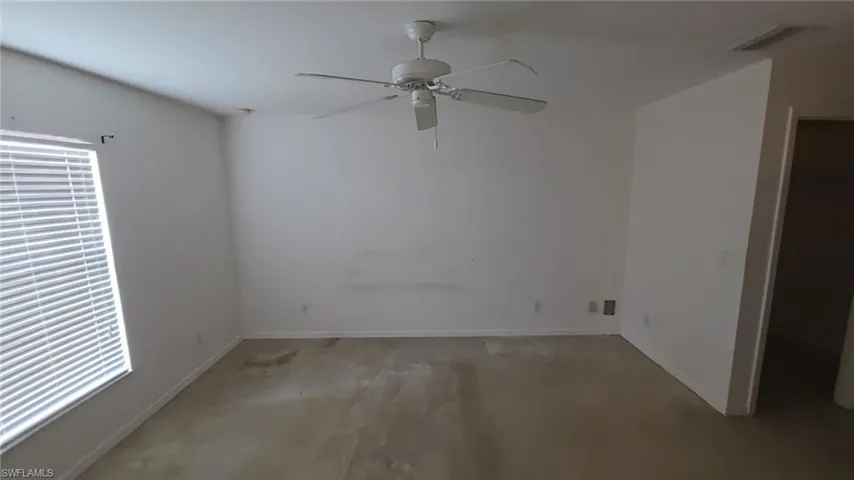 Unfurnished room featuring ceiling fan and light carpet