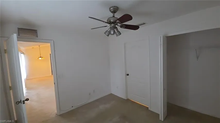 Unfurnished bedroom featuring a closet and a ceiling fan