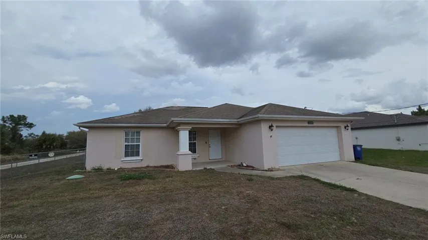 Single story home featuring stucco siding, an attached garage, and concrete driveway