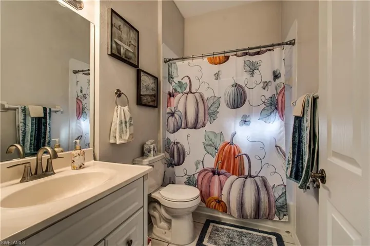 Full bathroom with vanity and shower / bath combo with shower curtain