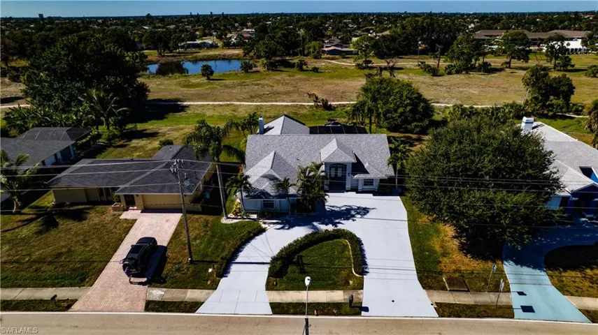 Aerial perspective of suburban area featuring a nearby body of water