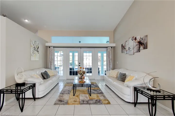 Living room featuring french doors and light tile patterned floors