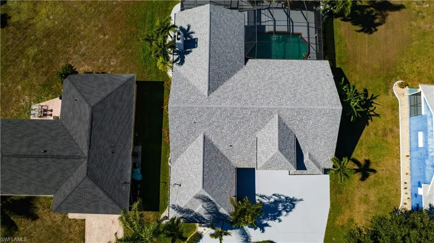 Aerial view of property and surrounding area with a pool