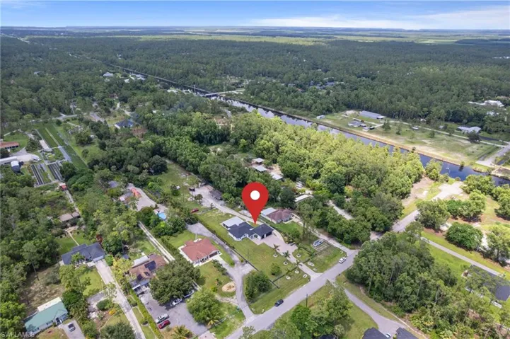 Primarily cleared 1.59 acre lot with a variety of tropical fruit trees, and drive around access.