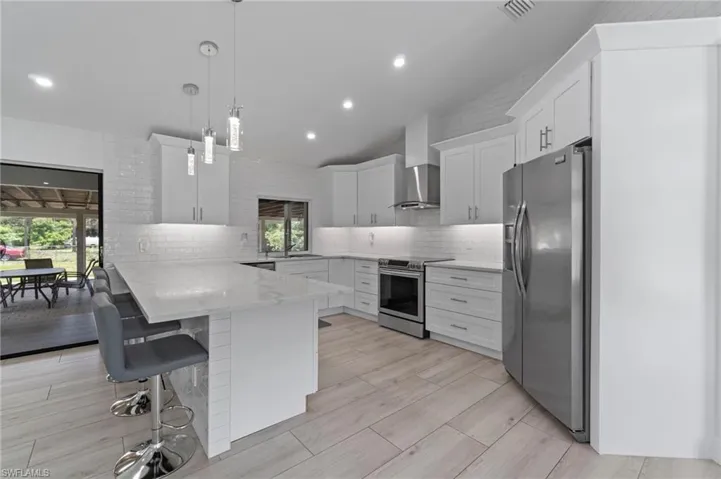 Quartz countertops and stainless appliances along with a passthrough window out to the expansive patio make this a great entertaining home.