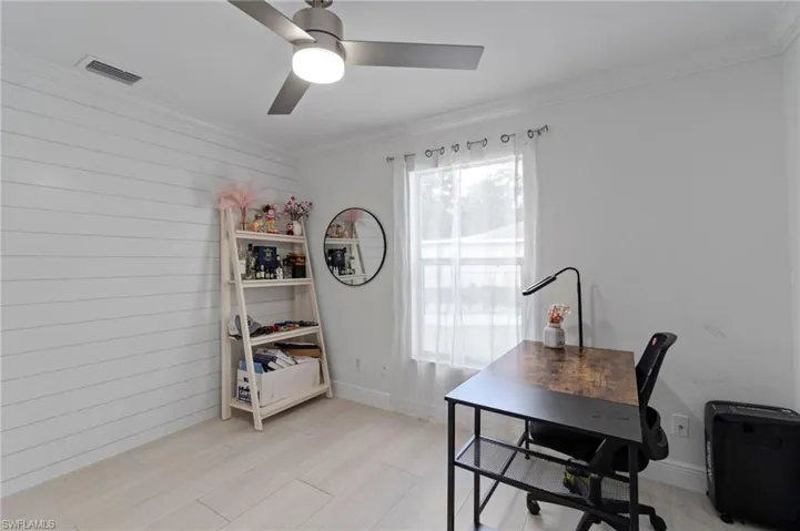 Opposite the featureaccent wall, shiplap adds additional character to this guest room.