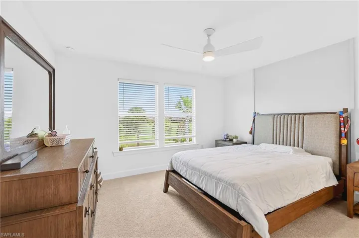 Bedroom with light carpet and ceiling fan