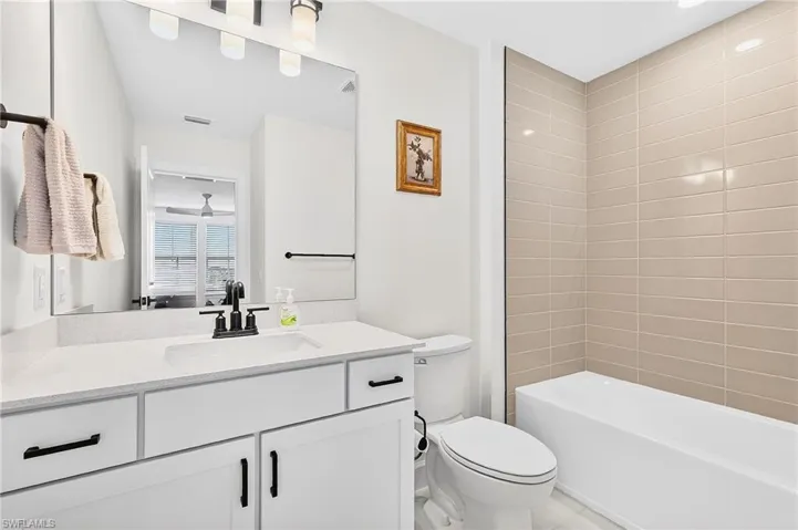 Full bath featuring vanity and shower / tub combination